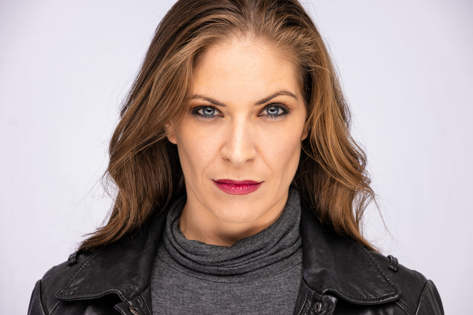 Actor headshot of Cat in a leather jacket, direct gaze