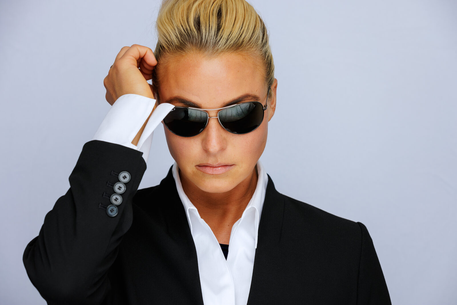 Editorial headshot of Jennifer in a suit and sunglasses