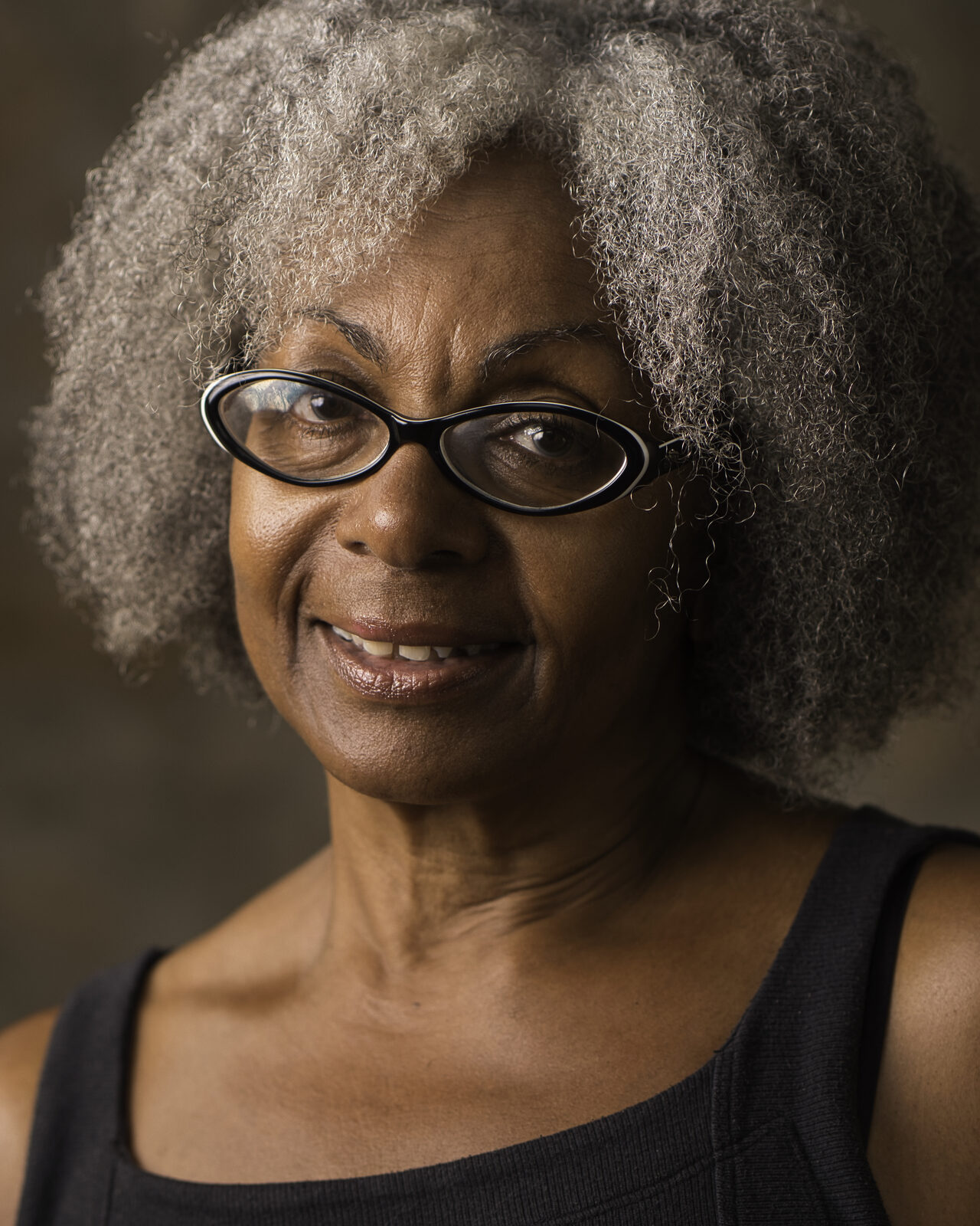 Dramatic actor headshot of Heather against a dark background